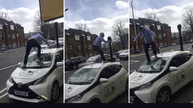 Footage shows a man stamping on the roof of the car and trying to remove its mounted camera