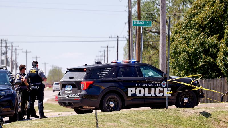 Police investigate after people were found dead in a home in Oklahoma City on Monday (Nathan J Fish/The Oklahoman via AP)
