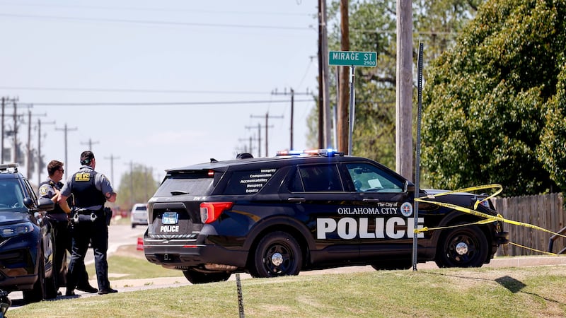 Police investigate after people were found dead in a home in Oklahoma City on Monday (Nathan J Fish/The Oklahoman via AP)