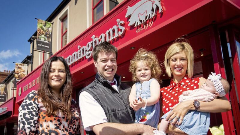James Cunningham Jr and his family Donna, Charlotte and baby Sophia pictured with Clare Clarke from First Trust Bank outside the expanded premises in Kilkeel 