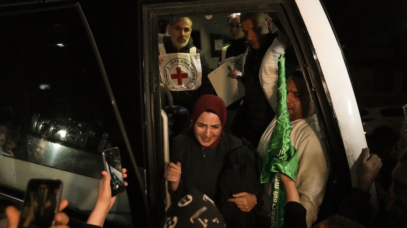 A woman smiles as she is welcomed after being released from prison by Israel, in the West Bank town of Ramallah (Nasser Nasser/ AP)