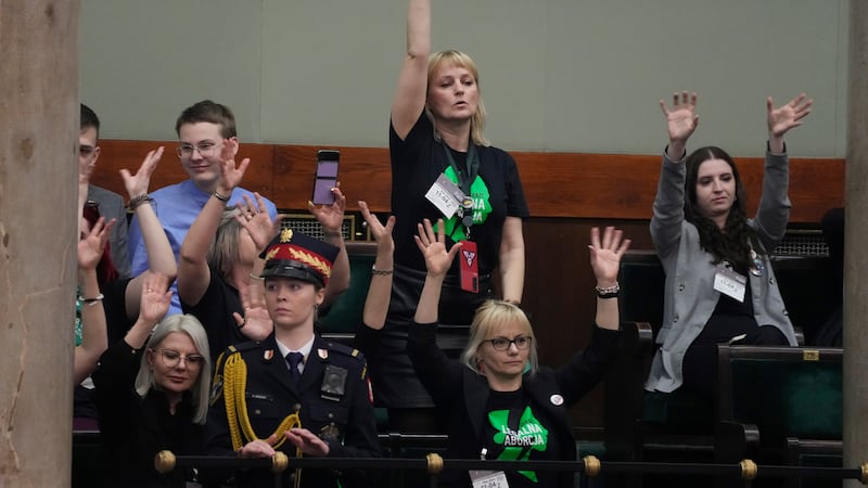 Abortion rights activists react during a debate in the Polish parliament from the gallery of the assembly, in Warsaw, Poland (Czarek Sokolowski/AP)
