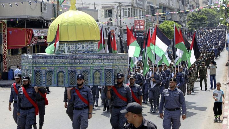 Officers from the Hamas national security force carry a model of the Al Aqsa Mosque while marching during a parade against Israeli arrangements in the contested Jerusalem shrine, in front of the Palestinian Legislative Council in Gaza City Picture: Adel Hana/AP 