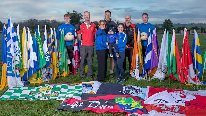 Loughinisland have launched the 'Field of Flags' fundraising initiative to develop new state-of-the-art grounds, while also raising money for two-year-old Leo Moley. Included are (front row, left) Louise Kearney, club chair and Leo's mum Laura with the toddler, alongside (back row, from left) the Down U20's Ulster Championship player of the year Oisin Savage, former Down stars Alan Molloy, Dan Gordon, double All-Ireland winner Gary Mason, as well as Loughinisland and Down player Rory Mason, who is Leo's uncle. Pictures by Raphael Mason Photography