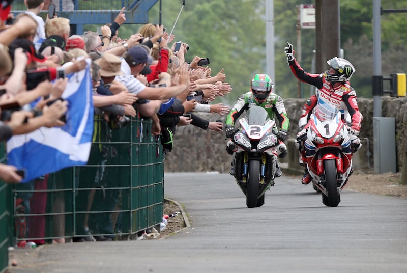 TOP MAN: John McGuinness celebrates his win in the Senior race yesterday