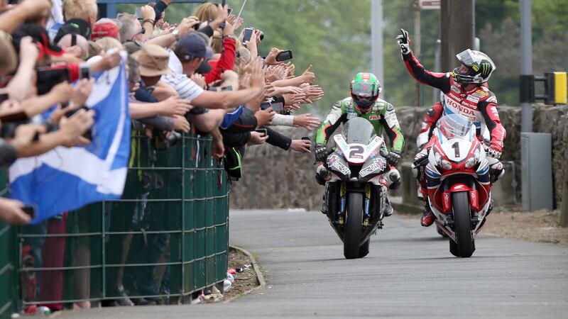 TOP MAN: John McGuinness celebrates his win in the Senior race yesterday
