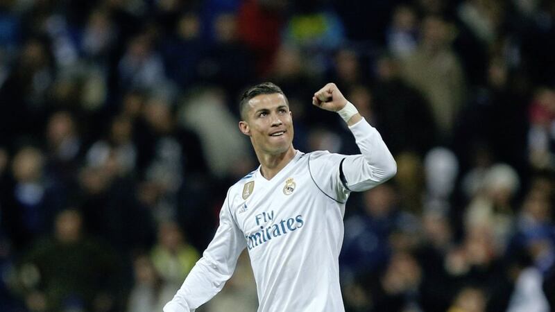 Real Madrid&#39;s Cristiano Ronaldo celebrates after scoring his side&#39;s second goal during the Champions League Group H match between Real Madrid and Borussia Dortmund at the Santiago Bernabeu. The Portuguese striker became the first player to score in all six group games of a Champions League season 