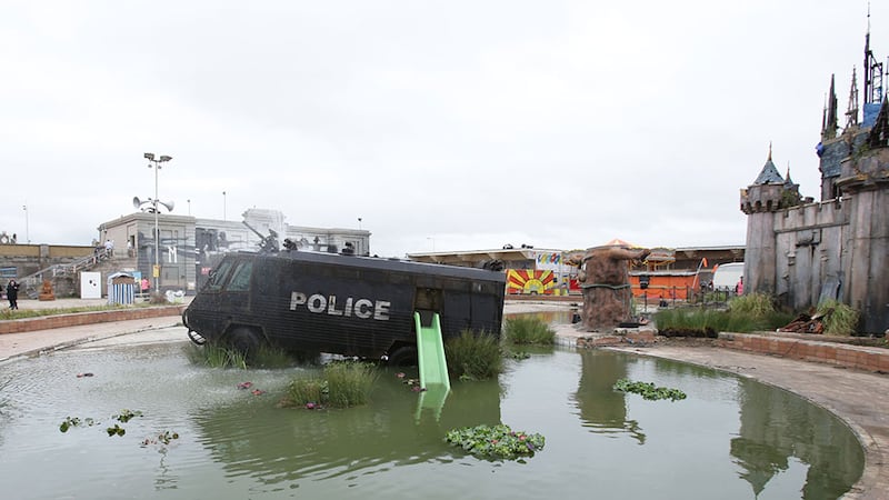 An amour plated police riot van built to serve on the streets of Northern Ireland in a lake, during the press day for the artist Banksy's biggest show to date, entitled 'Dismaland', at Tropicana in Western-super-Mare, Somerset&nbsp;