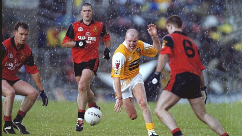 Antrim captain Anto Finnegan in a race for the ball with Down&#39;s Paul Higgins, Gregory McCartan and Paul Shields in a Casement Park classic. Pic Ann McManus 