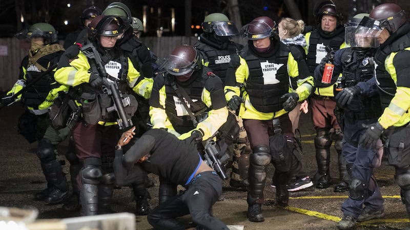 A demonstrator is arrested by police for violating curfew and an order to disperse during a protest against the police shooting of Daunte Wright, late Monday, April 12, 2021, in Brooklyn Center, Minnesota<br />(AP Photo/John Minchillo)&nbsp;