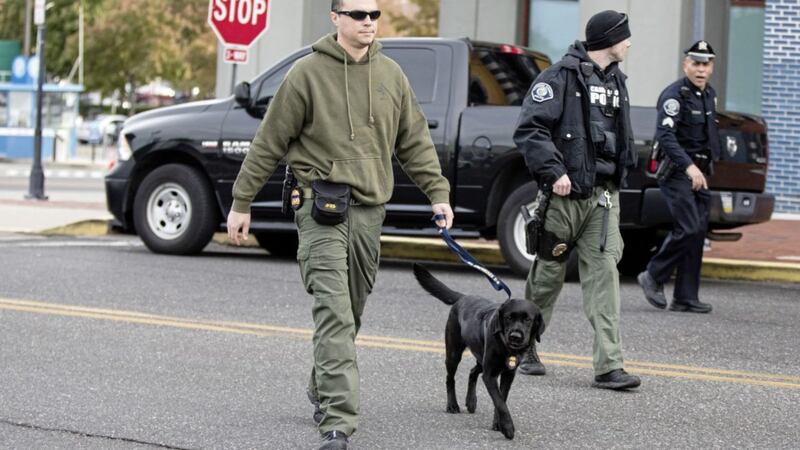 A law enforcement officer with a dog walks from New Jersey Democratic Sen. Cory Booker&#39;s office in Camden, N.J., on Friday, Oct. 26, 2018. The FBI says a suspicious package addressed to Booker has been recovered in Florida and is similar in appearance to the other ones received in the last few days. Picture by Matt Rourke/AP 