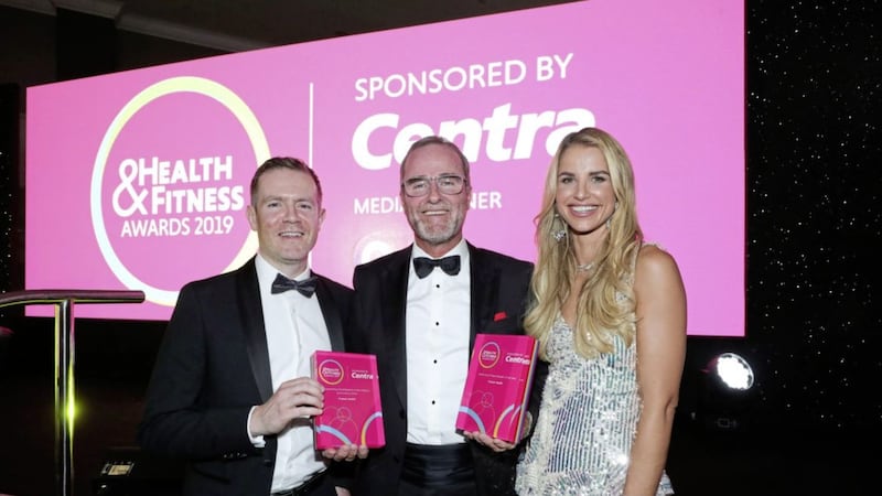 Brendan Gallen, head of marketing at sponsor Centra NI, presents the outstanding contribution to the industry award to Paul Maconaghie from Framar Health at the NI Health &amp; Fitness Awards. Looking on is co-host Vogue Williams. Photo: Kelvin Boyes/PressEye 
