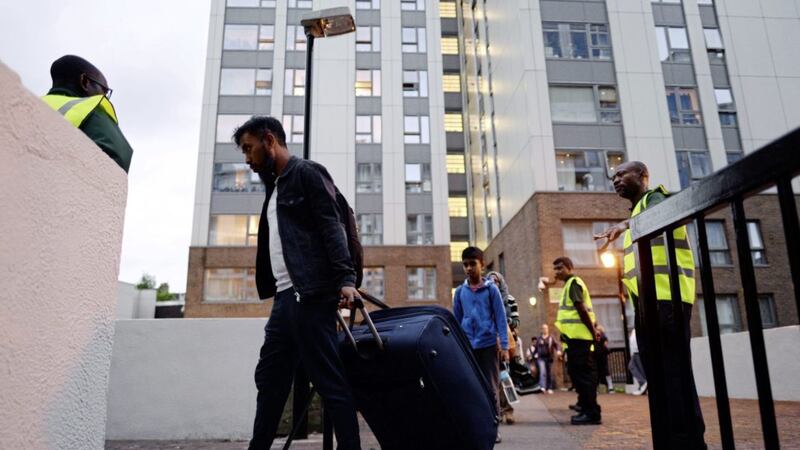 Residents leave the Taplow tower block on the Chalcots Estate in Camden, London on Friday. Picture by Stefan Rousseau, Press Association 