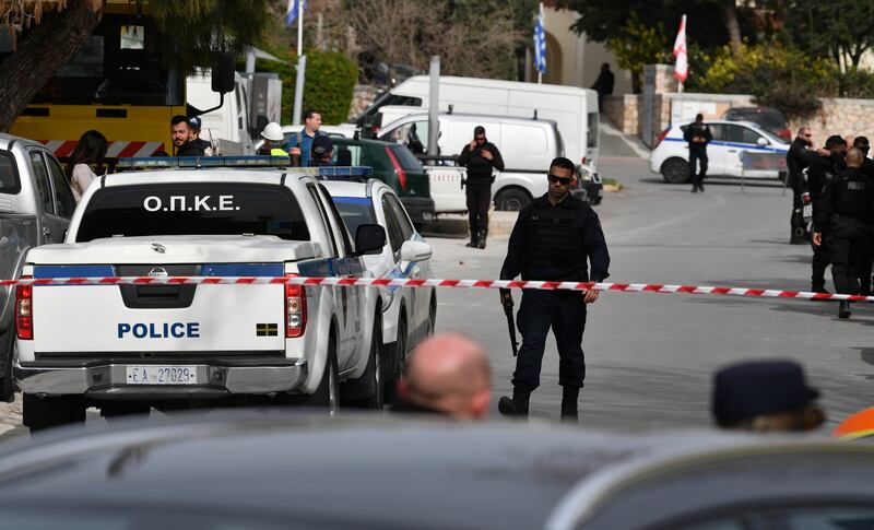 Police cordon off a road in Glyfada, Athens, after the shooting (Michael Varaklas/AP)