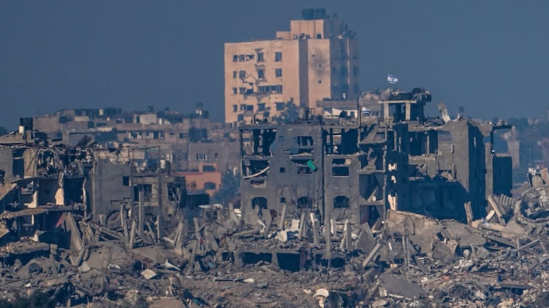 Israeli flags stand on the top of destroyed buildings in the Gaza Strip (Ariel Schalit/AP)