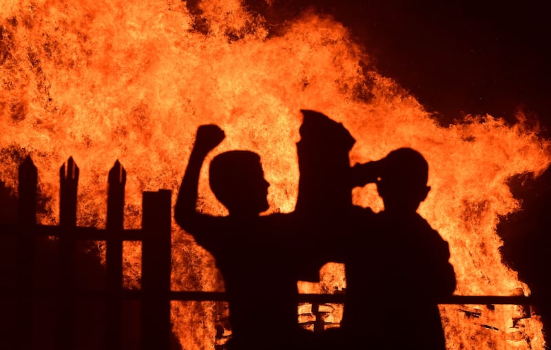 Young people at the bonfire at Conway Street in Belfast on the Eleventh Night. Picture by Pacemaker Press