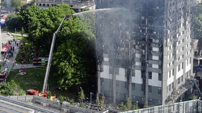 Firefighters spray water after a fire engulfed the 24-storey Grenfell Tower in west London. 