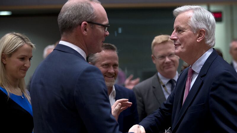 European Union chief Brexit negotiator Michel Barnier, right, shakes hands with T&aacute;naiste Simon Coveney during a meeting at the European Council headquarters in Brussels&nbsp;