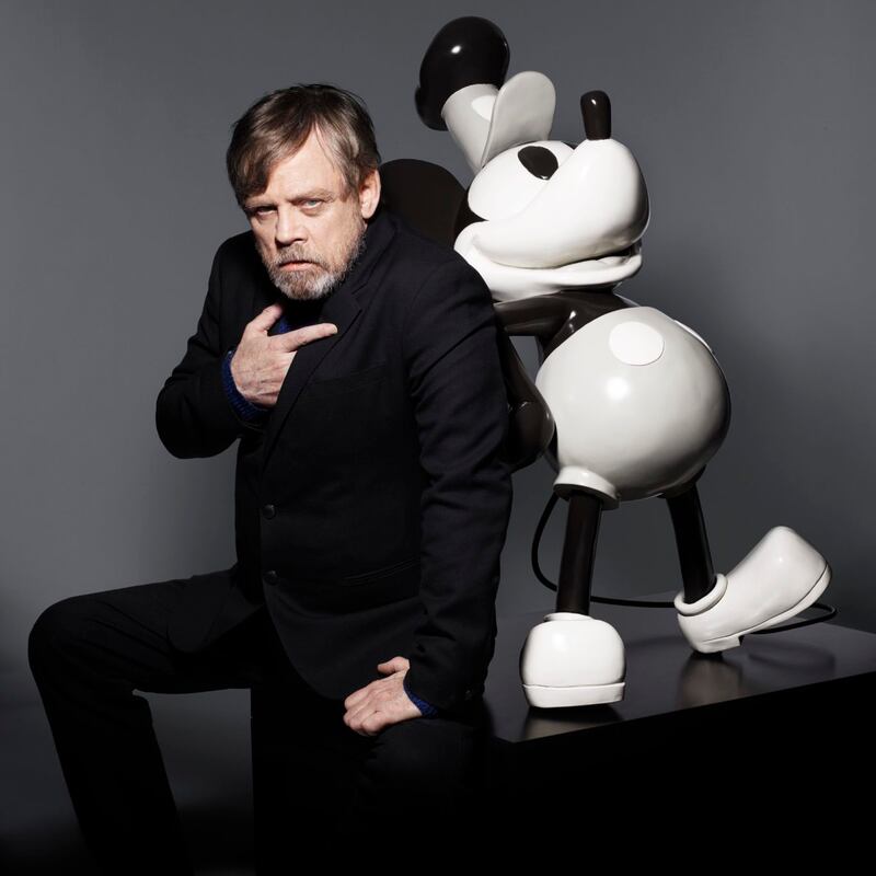 Star Wars star Mark Hamill poses alongside a special, commemorative statue of Mickey Mouse. 