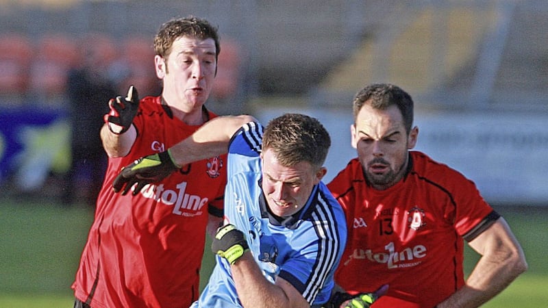 Rostrevor&#39;s Brian Keenan and Shaun Parr close in on Gary Merrit during the Reds&#39; Ulster IFC semi-final win over Milford. Picture by Bill Smyth 