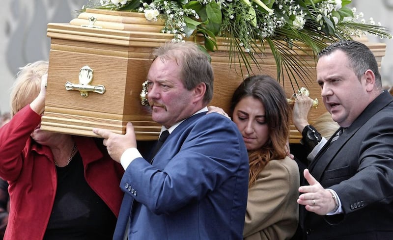 Dean McIlwaine's family and frineds comfort each other at funeral in Carnmoney.&nbsp;Picture by Justin Kernoghan.
