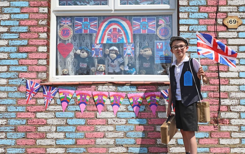Alex Glover, 10, dressed as a Second World War evacuee outside his home in Sittingbourne, Kent, where he has created a VE Day theme which includes a tribute to 100-year-old Captain Tom Moore 