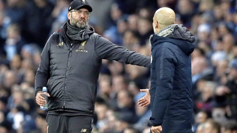 Liverpool manager Jurgen Klopp (left) speaks to Manchester City manager Pep Guardiola during the Premier League match at the Etihad Stadium on Thursday evening 