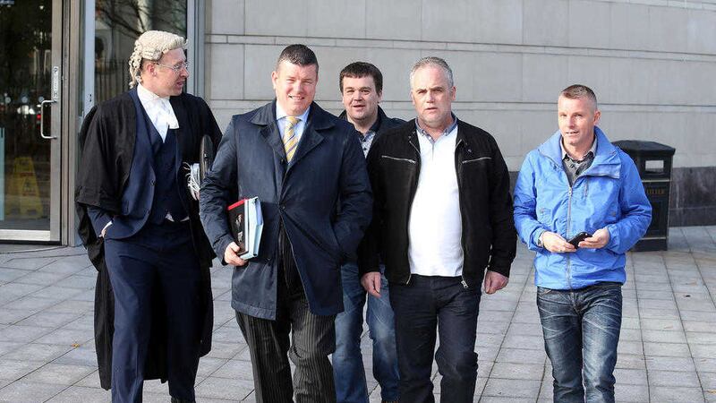Barrister Sean Devine and Solicitor Niall Murphy with Lurgan republicans Damien Duffy, Paul Duffy and Shane Duffy leaving Laganside court this week. Picture by Mal McCann 