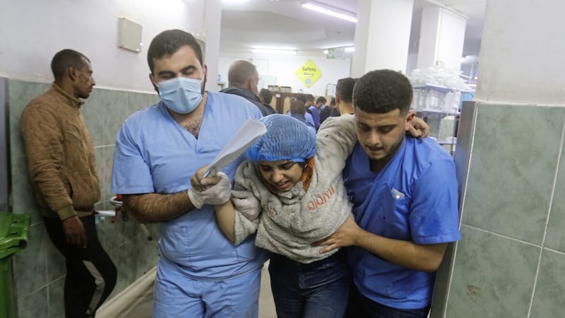 Palestinians wounded in the ongoing Israeli bombardment of the Gaza Strip arrive at a hospital in Rafah 