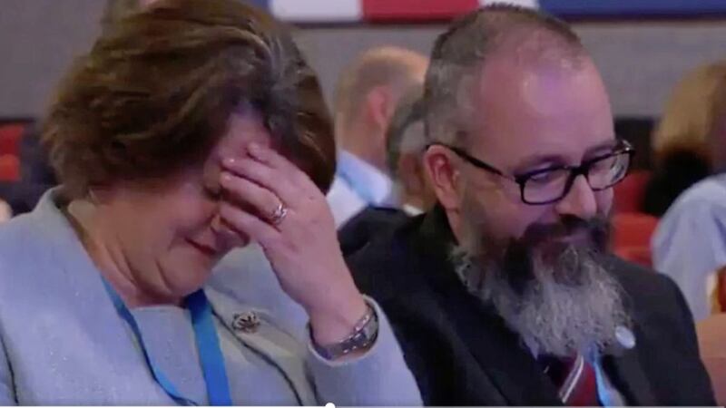 Arlene Foster is seen laughing and holding her head in her hands as Karen Bradley praises the BBC. 