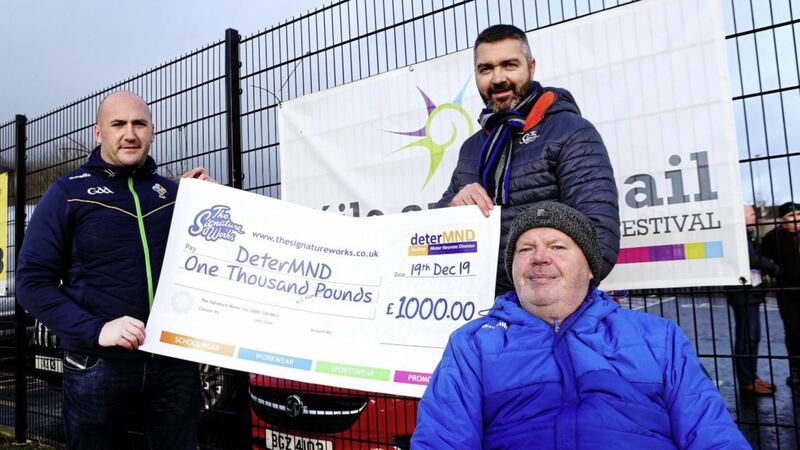 Steve Collins (centre) of Bangor-based printing and embroidery company Signature Works and Kevin Gamble (St Paul&#39;s) are pictured with former Antrim gaelic football star Anto Finnegan (right) as they hand over a cheque to charity DeterMND, established on behalf of Anto to raise awareness and funds to tackle Motor Neurone Disease (MND). Picture by Seamus Loughran 
