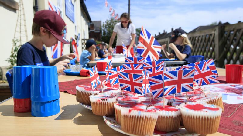 Pupils still attending Breadsall Primary School in Derby ate in the sunshine with Union flag bunting above their heads.