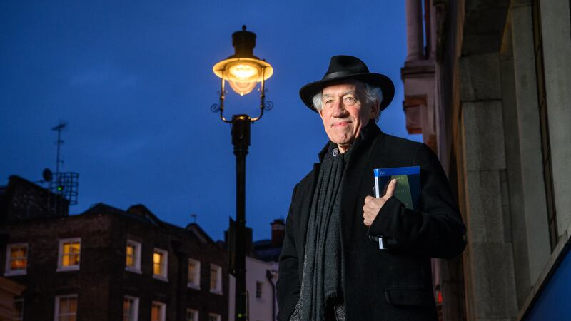 Actor Simon Callow stands under one of four gas lamps along Russell Street in Covent Garden