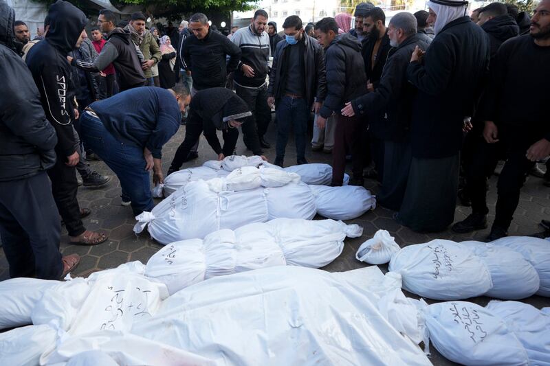 Palestinians mourn their relatives killed in the Israeli bombardment of the Gaza Strip in Deir al Balah (Adel Hana/AP)