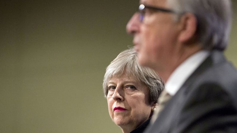 British Prime Minister Theresa May listens as European Commission President Jean-Claude Juncker speaks during a media conference at EU headquarters in Brussels&nbsp;