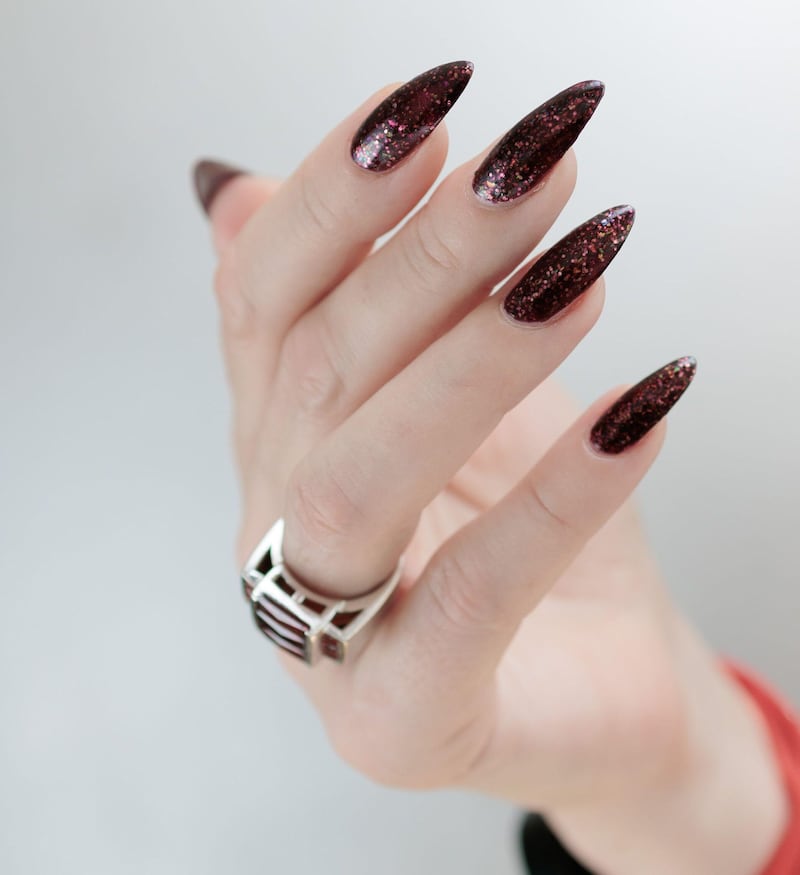 Hand with black cherry nail polish