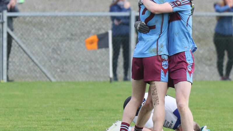 Darragh McBrien and Josh Horan of St Michael's, Enniskillen celebrate while some of the St Patricks, Maghera players can only lie down in dismay.&nbsp;