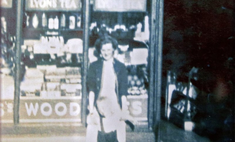 Annie Torley pictured outside the family shop and home in Winetavern Street when she was aged about 16. Picture by Mal McCann 