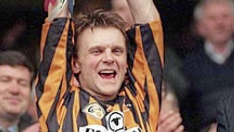 Jubilant Crossmaglen captain Jim McConville lifting the Andy Merrigan Cup on St Patrick&#39;s Day 1997. 
