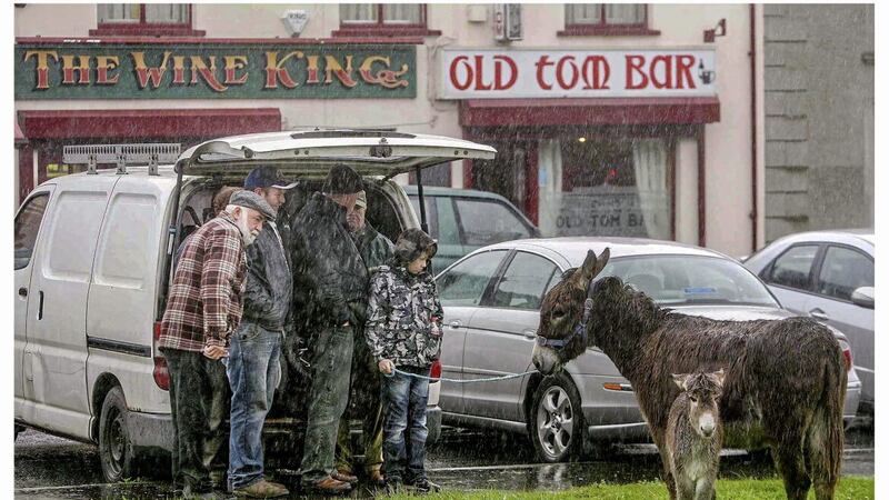 The annual Castlewellan fair day sees thousands descend on the County Down town. All wasn&#39;t fair on this day in in July 2012 though, as an unexpected downpour sent people running to find shelter anywhere they could. PICTURE: MAL MCCANN 