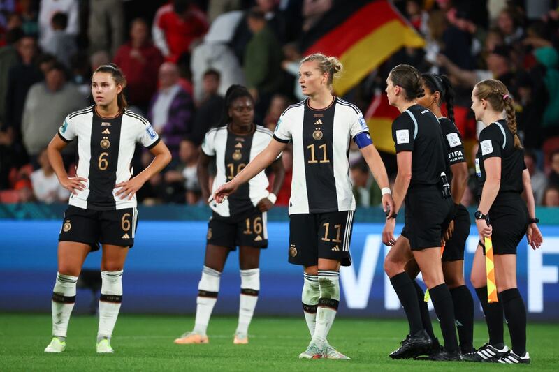Germany players stand dejected on the pitch