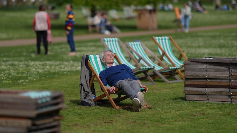 People relaxing in the warm weather in St James’s Park, London