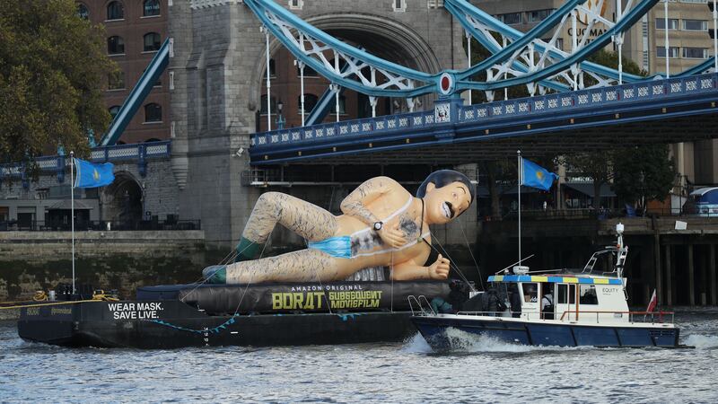 A floating inflatable has passed the Tower of London to promote Borat Subsequent Moviefilm.
