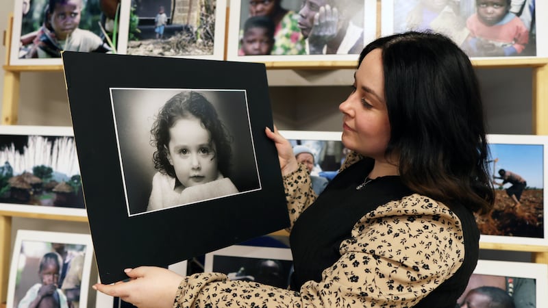 Hayley Russell looks at  picture of herself as a child during A exhibition of Hugh Russell’s work to celebrate 40 years of Photography at Christian Brothers camera Club in North Belfast.