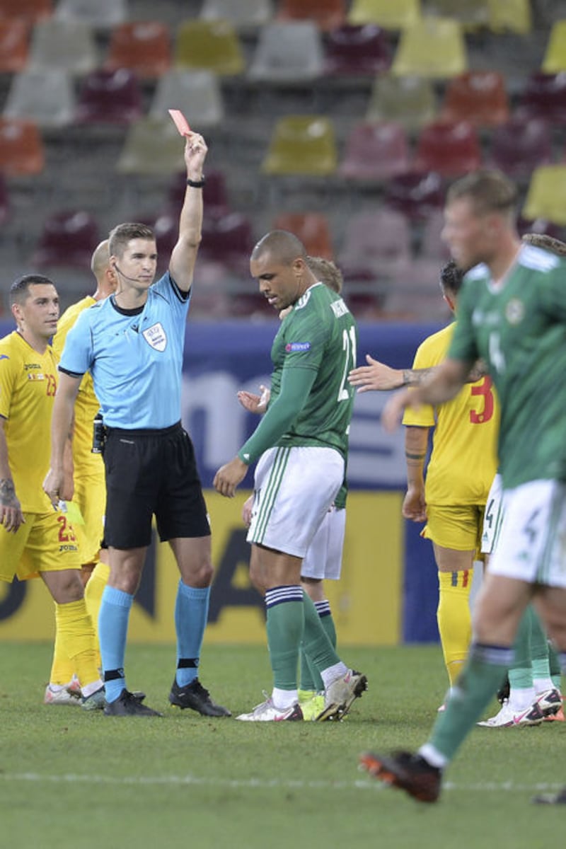 Referee Francois Letexier shows the red card to Northern Ireland's Josh Magennis, second from right, during the UEFA Nations League soccer match against Romania at the National Arena stadium in Bucharest, Romania, Friday, Sept 4, 2020.<br />(AP Photo/Alexandru Dobre)&nbsp;
