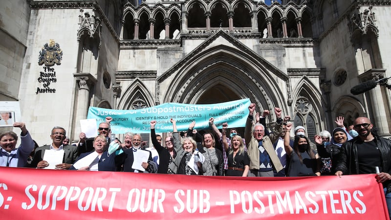 Former post office workers celebrate outside the Royal Courts of Justice, London, after having their convictions overturned by the Court of Appeal in 2021