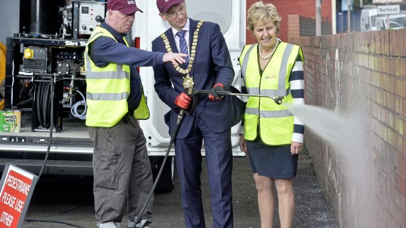 Belfast&#39;s lord mayor Brian Kingston trying his hand at graffiti removal alongside Cheryl Lamont, chief executive of the Probation Board 