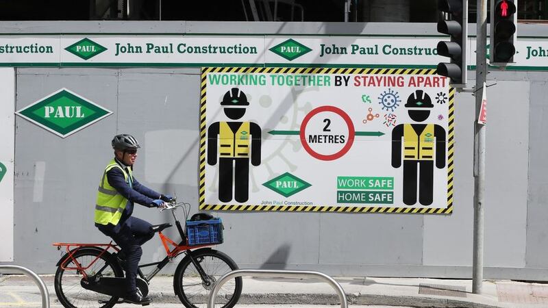 &nbsp;A cyclist passes the John Paul Construction site on Dublin's Townsend Street which has had to close temporarily after a number of staff tested positive for Covid-19.