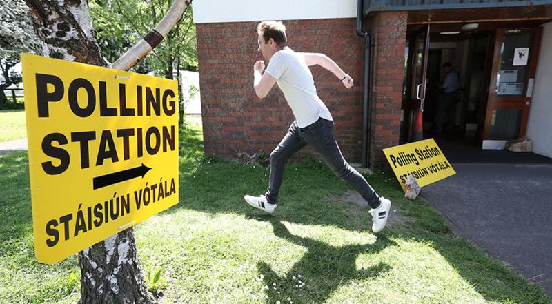 &nbsp;A man breaks into a run outside a polling station in Dublin. Picture by Niall Carson, PA