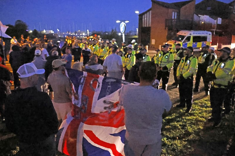 Migrants arrive in Gosport as protesters gather at scene